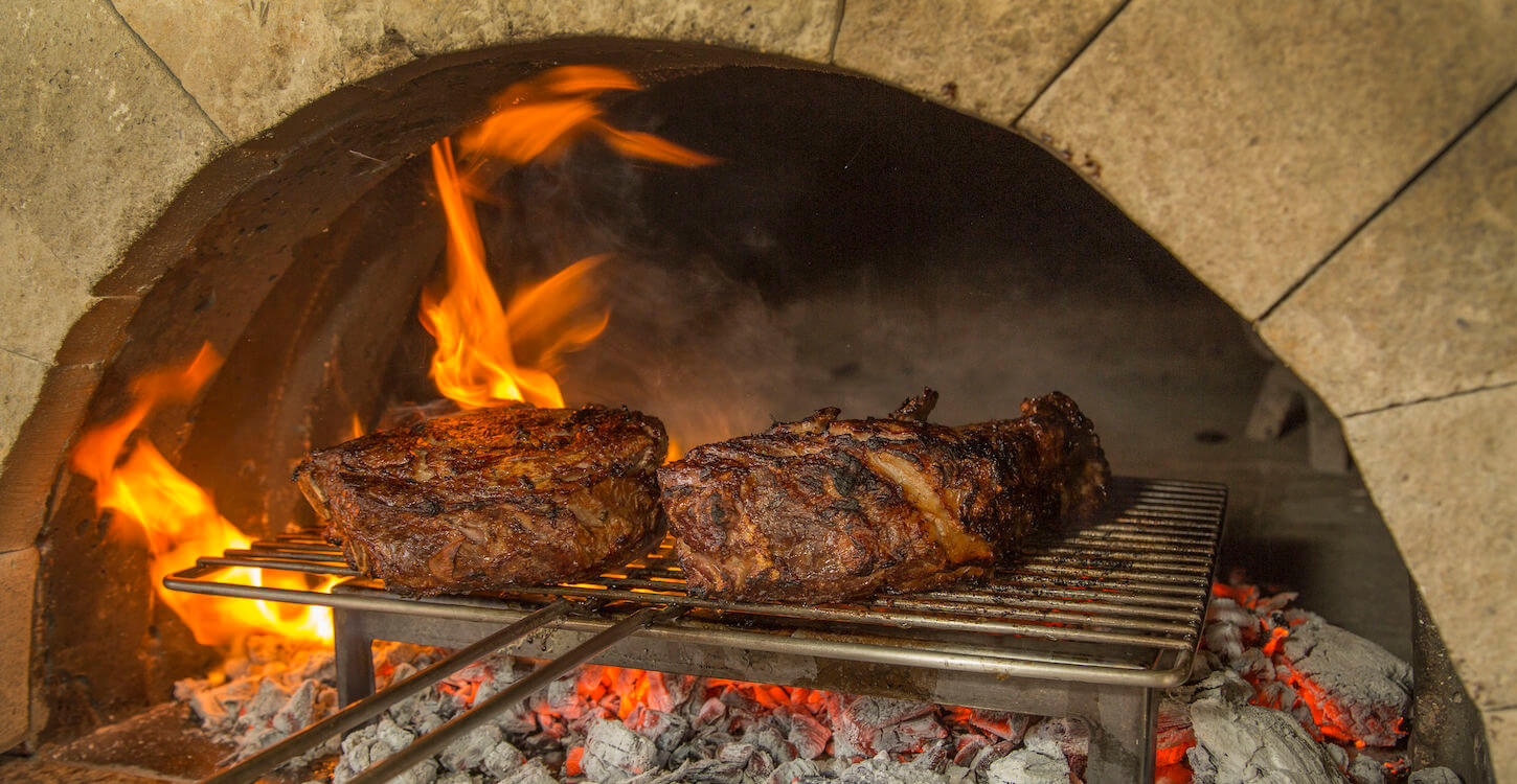 Gilling meat over coals in Mugnaini oven