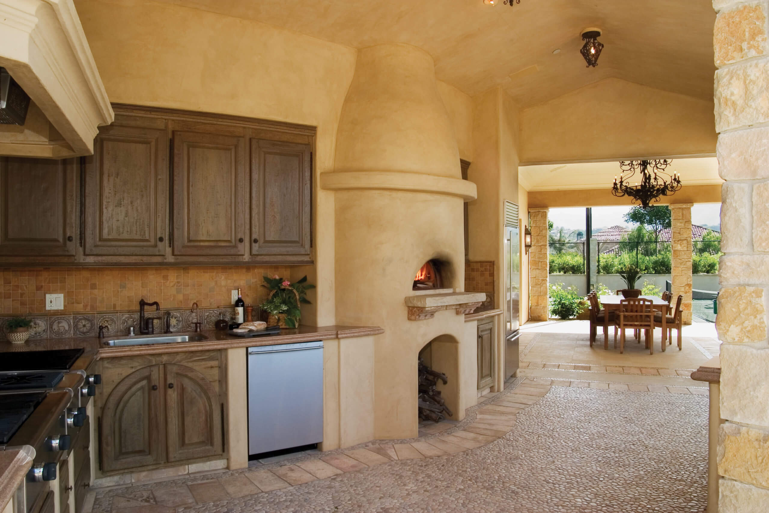 residential mediterranean style kitchen with Mugnaini wood oven